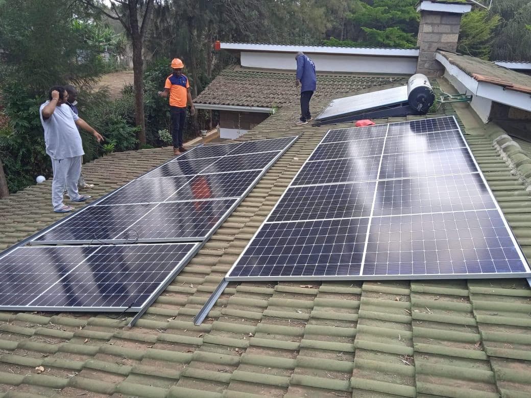 Helum team installing solar panels on a residential rooftop