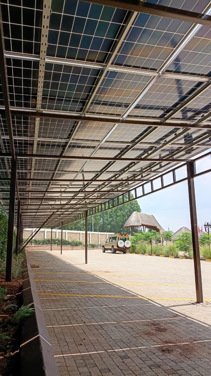 Solar parking canopy generating power over a paved yard